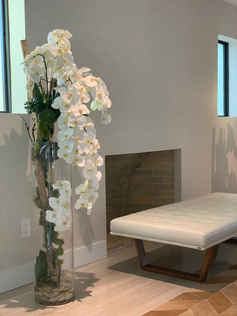 Oversized 39′′ Rota cylinder with multiple stems of Phalaenopsis orchids